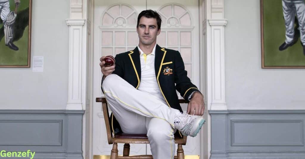 Pat Cummins, sits on a chair holding a cricket ball, looking confidently at the camera.