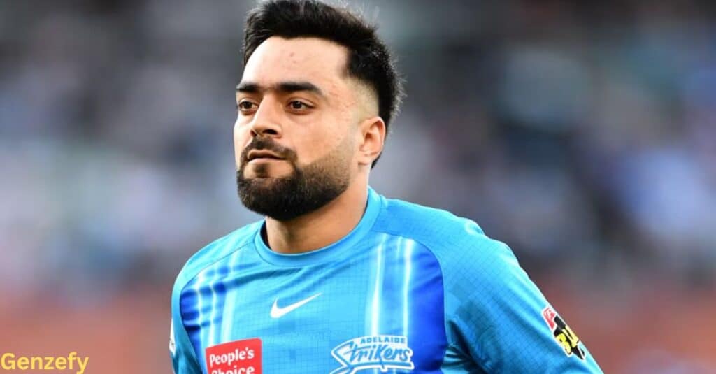 Rashid Khan in a blue shirt, poses for the photo with a friendly expression.
